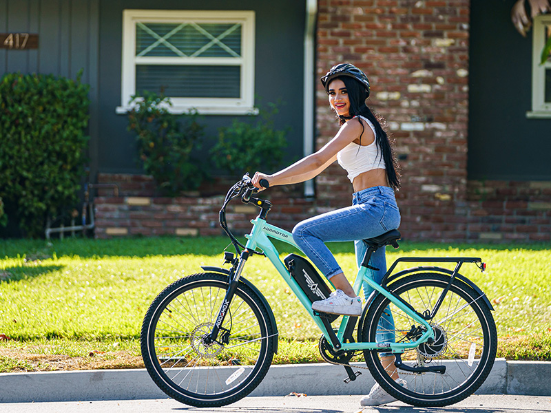 A lady riding a light blue Citypro ebike 