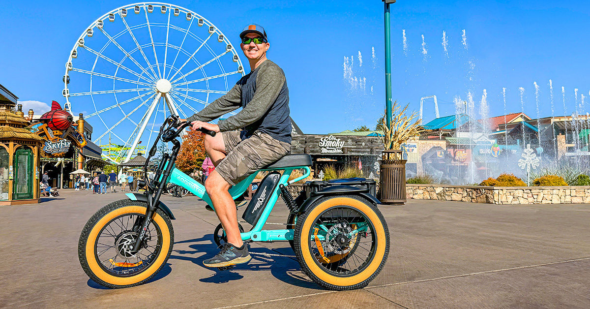 a man riding an adult electric trike with a big smile