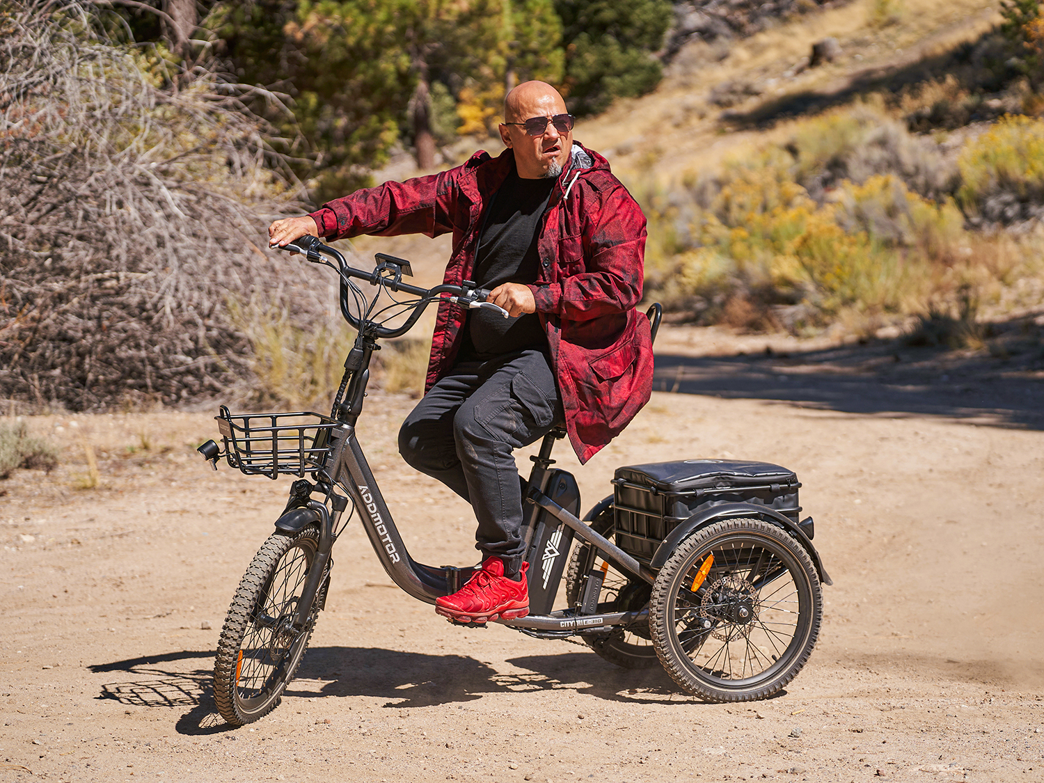Elderly man rides Addmotor Citytri E-310 folding electric tricycle outdoors.