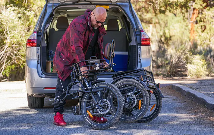A senior folding his Citytri E-310 Plus  Folding Electric Trike into his car