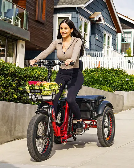 a woman riding a triketan m330f etrike on a sllope