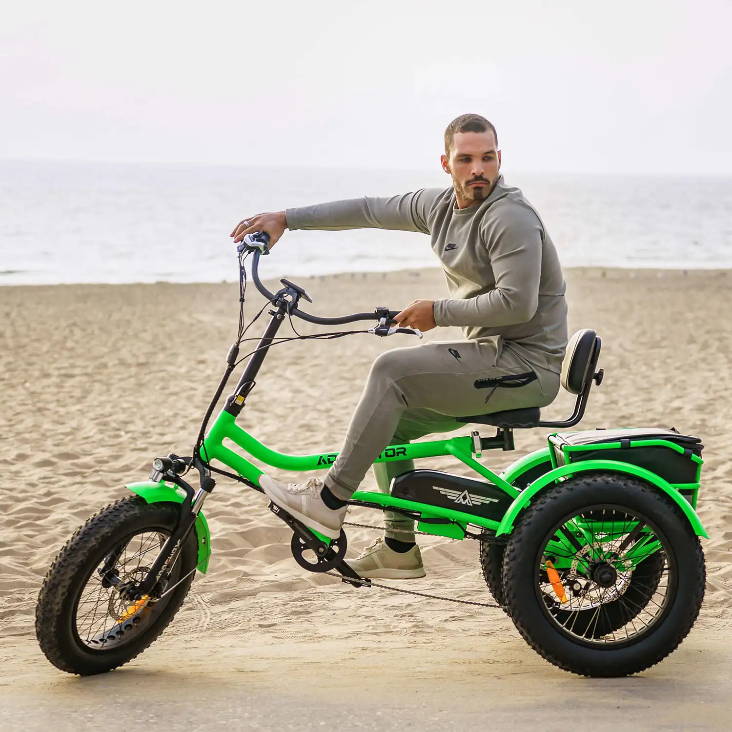 A man is riding Addmotor M-360 on the beach