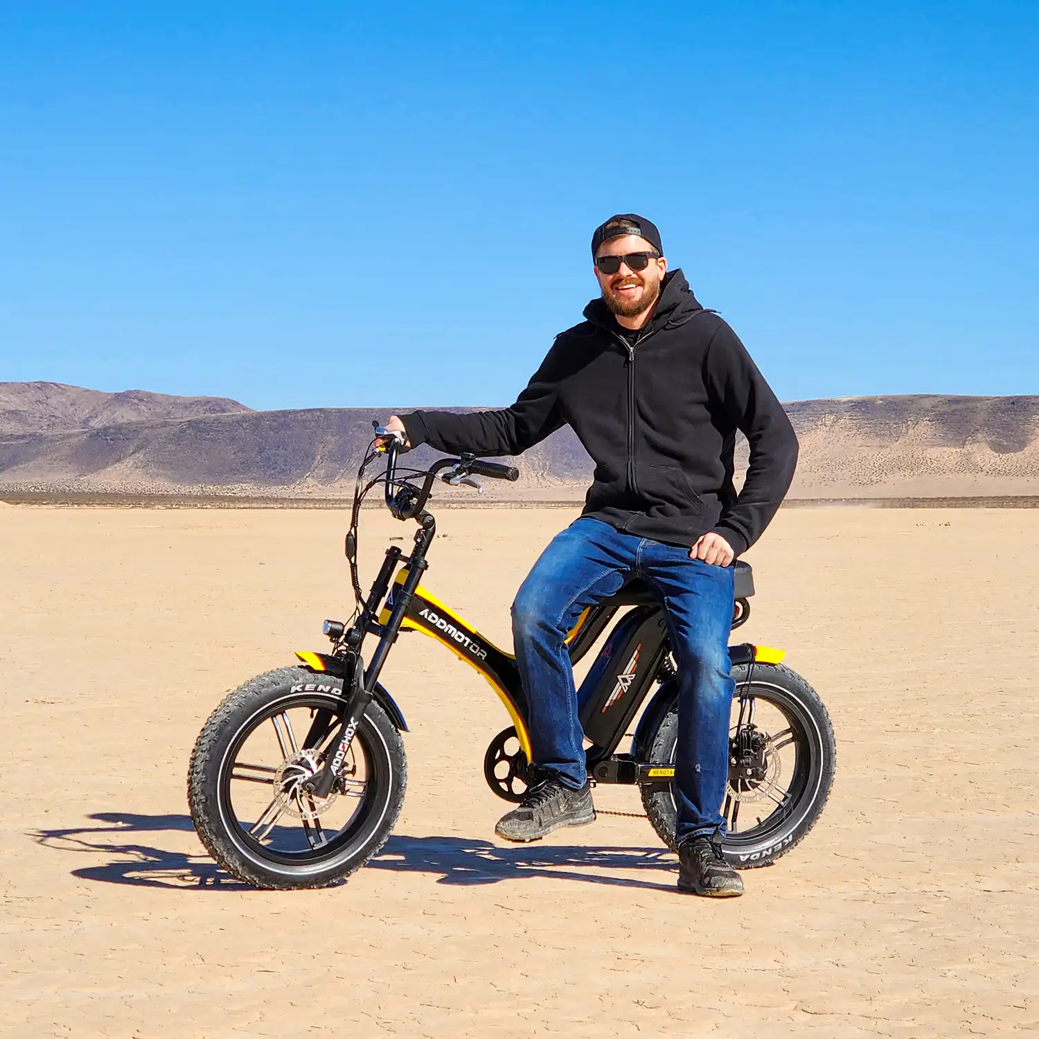 A man wearing sun glasses is riding Addmotor Soletan M-66X