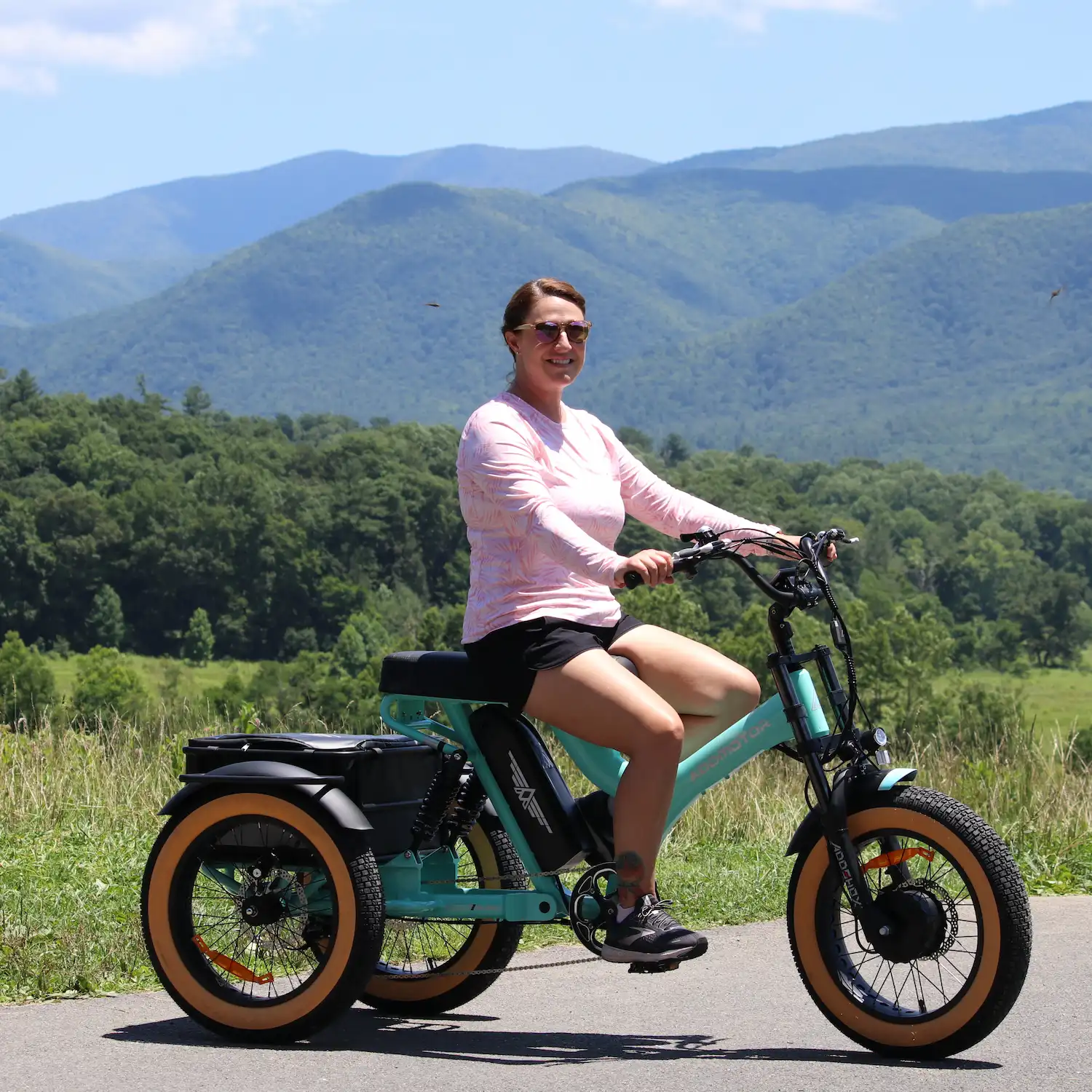 A woman is riding Addmotor electric tricycle outdoor