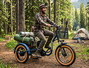 An adult riding the Addmotor U-750 fat tire electric trike in Fixed Mode for a stable cargo run