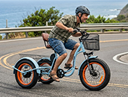 A rider cornering smoothly on a fat tire electric trike, utilizing the pivot steering trike mechanism for a dynamic lean-to-turn feel.