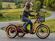 A rider cornering smoothly on a tilting electric trike for adults, showing the leaning mechanism trike in action